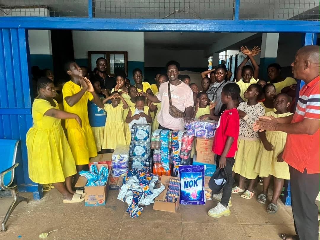 Pupils celebrating as donations are handed over