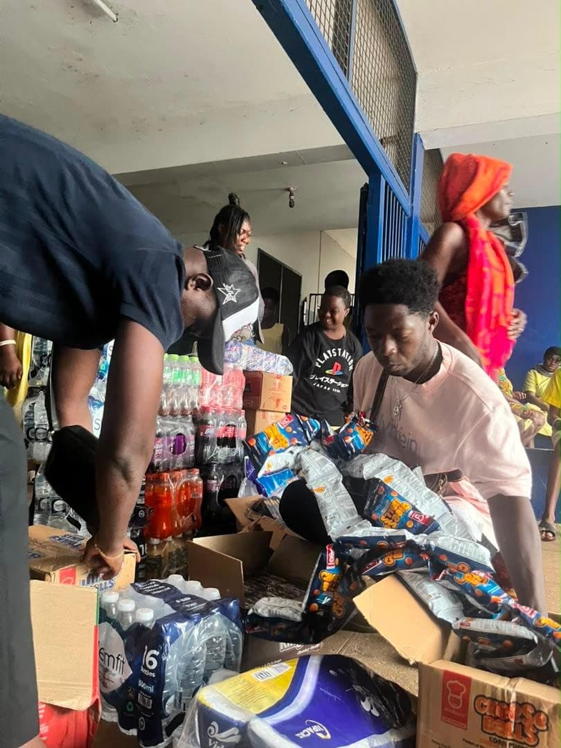 Volunteers unpacking donated drinks and toilet rolls